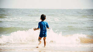 Child running in sea